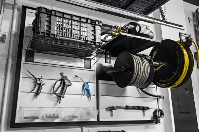 Wall-mounted hose reels and car-detailing equipment.