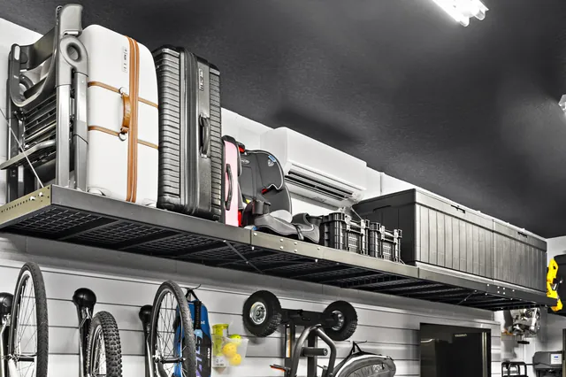 Overhead shelving accommodates bulky suitcases and folded furniture, while high-capacity black boxes keep seasonal and infrequently used belongings together.