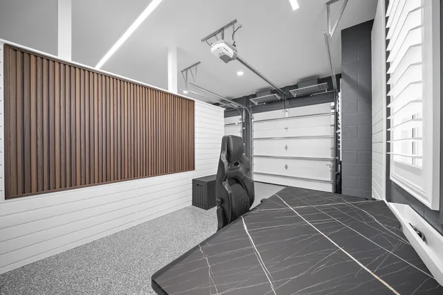 A wood-slat backdrop gives video calls a finished setting and brings warmth to the work and fitness zone.