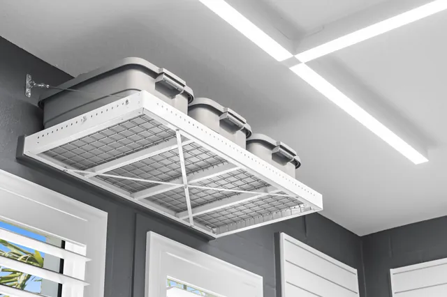 Shelving above the window adds storage while leaving the window and work surface clear.
