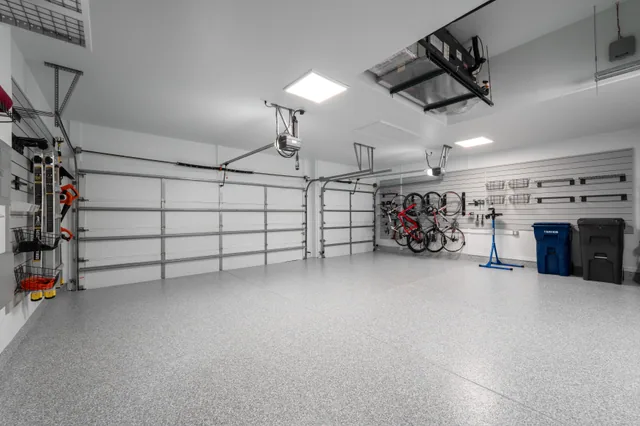 With the garage doors closed, bike storage and wall-mounted equipment leave the parking floor open.