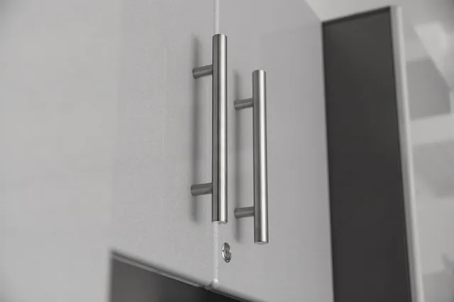 Close view of cabinet doors, handles, and a lock.