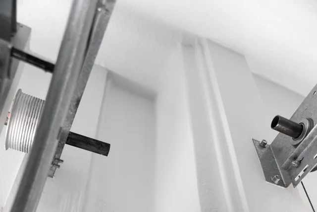 Fresh paint continues through the wall and ceiling transitions around the garage-door hardware, giving the less visible surfaces the same attention.