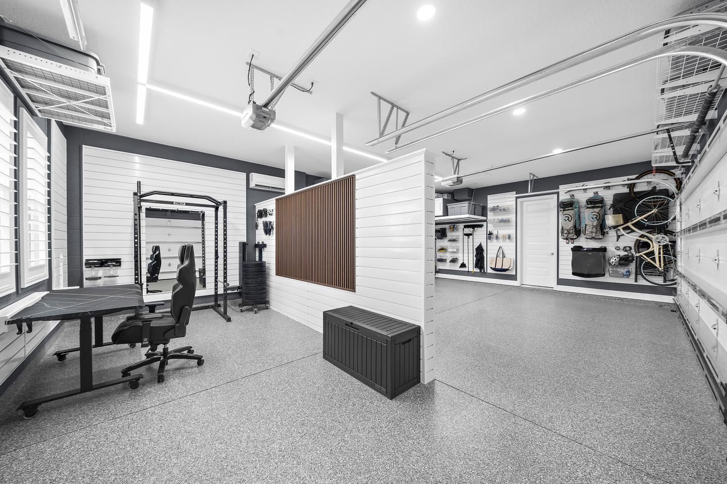 Custom partition separating the work and fitness zone from the open parking bay