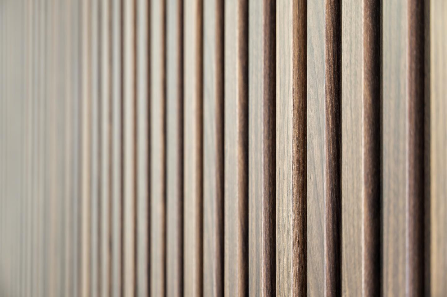 Close view of warm wood slats with dark recessed gaps