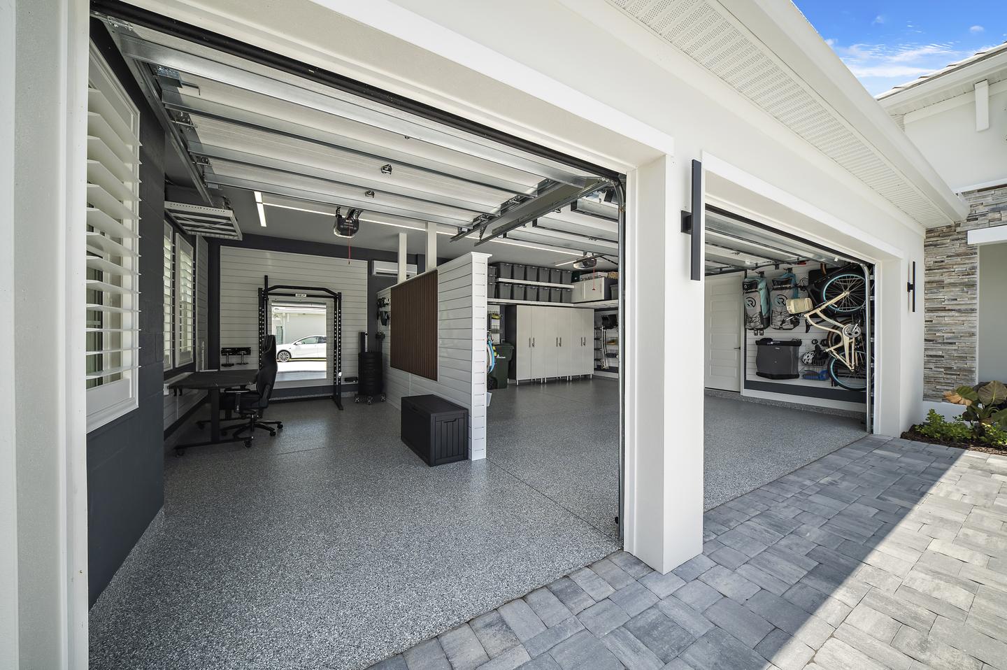Open garage bays showing a finished workspace alongside parking and perimeter storage