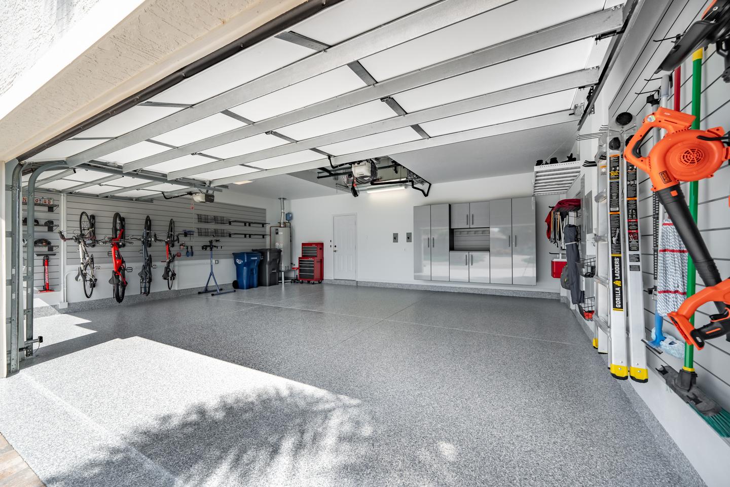 A completed garage with wall-mounted bikes, organized tools, and a clear floor