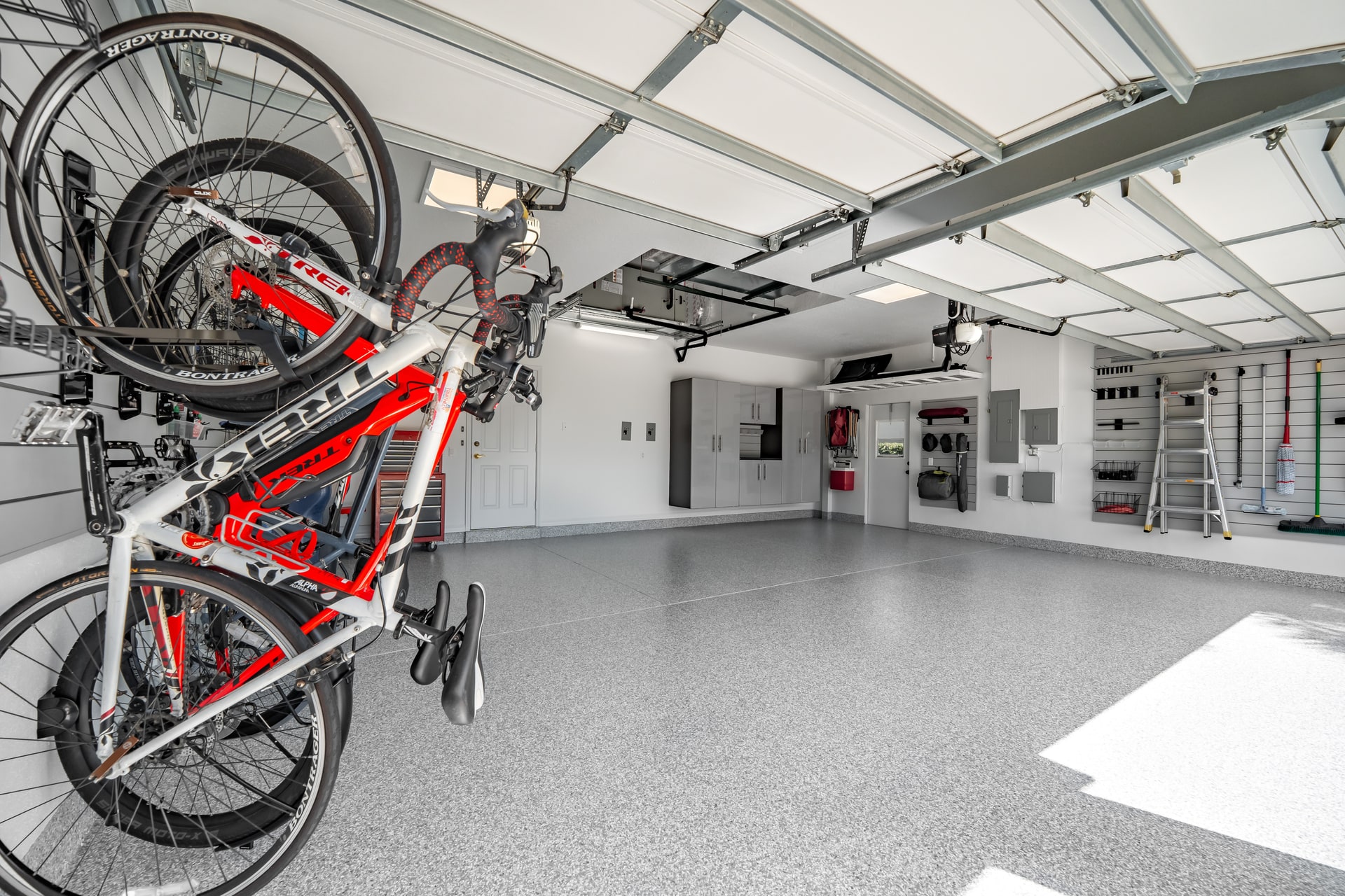 Wall-mounted bikes beside an open coated floor and perimeter storage