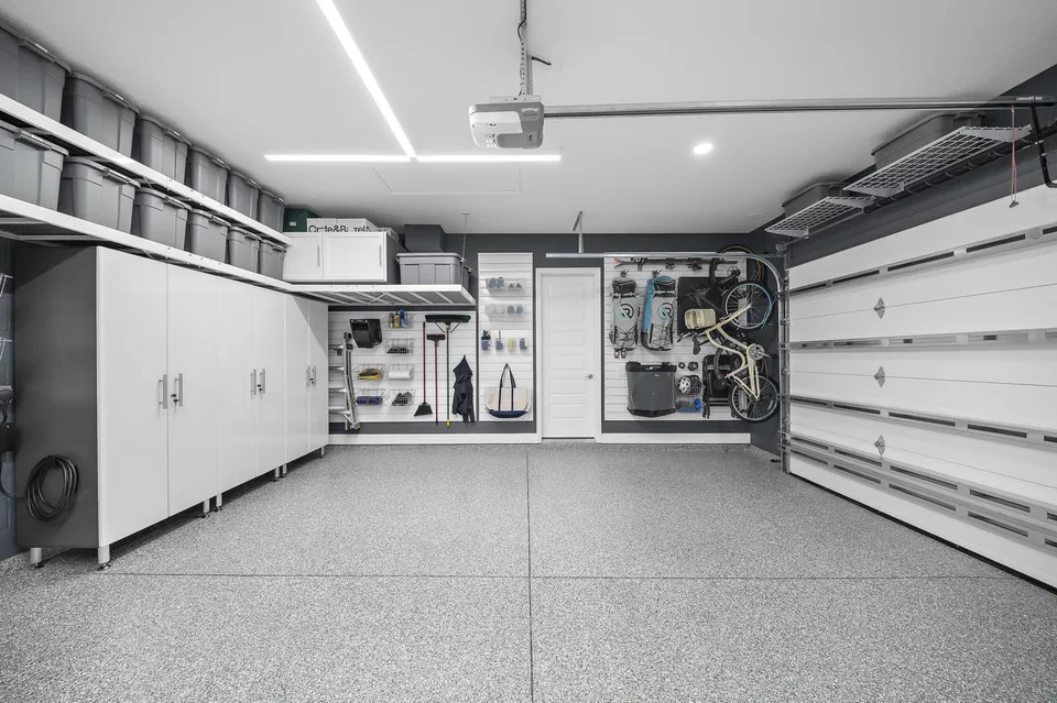 Storage stays along the walls and above the garage doors, leaving the center of the large bay open.