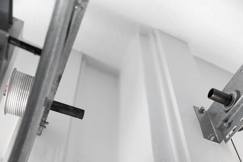 Freshly painted wall and ceiling transitions around the garage-door hardware.